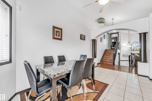 Dining area with tile flooring and a window with horizontal blinds - 6719 164 Ave, Edmonton, AB 