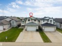 Two-story home with light-colored siding and a two-car attached garage - 6719 164 Ave, Edmonton, AB 