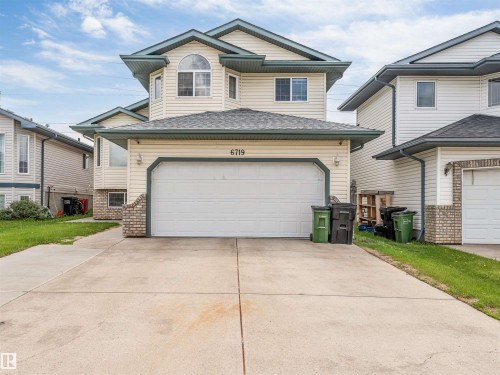 Two-story residence featuring light-colored siding and a two-car attached garage - 6719 164 Ave, Edmonton, AB 