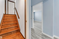 Hardwood staircase with natural wood-finish treads and risers - 