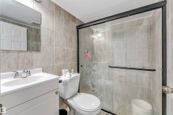 Bathroom featuring a white vanity with integrated sink, chrome faucet, and mirrored medicine cabinet - 