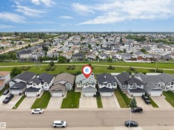 Aerial perspective showcasing a residential neighborhood with a prominent cul-de-sac - 