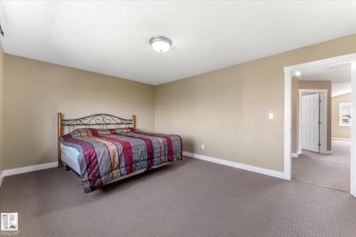 Spacious room featuring neutral-toned walls, recessed ceiling lighting, and wall-to-wall carpeting - 488 Macewan Road, Edmonton, AB 
