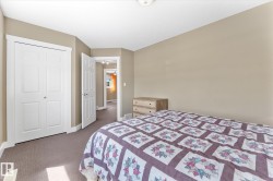 Carpeted room with a bi-fold closet, neutral wall paint, and white trim - 