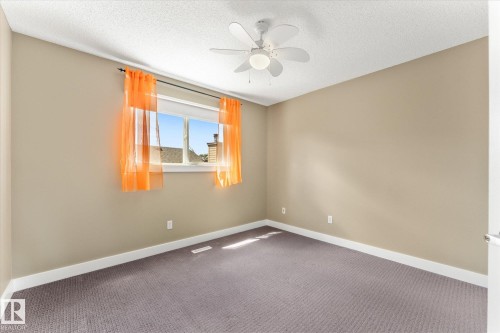 Neutral-toned walls complement the gray carpeting - 488 Macewan Road, Edmonton, AB 