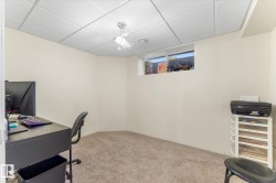 Carpeted room featuring a drop ceiling with recessed lighting - 