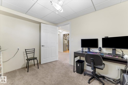 Carpeted room featuring a drop ceiling with recessed lighting - 488 Macewan Road, Edmonton, AB 