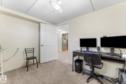 Carpeted room featuring a drop ceiling with recessed lighting - 