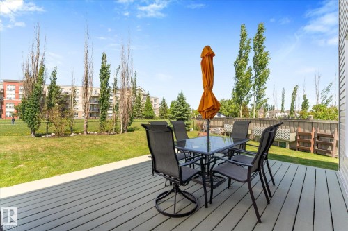Spacious outdoor deck with composite decking and a privacy wall - 488 Macewan Road, Edmonton, AB 
