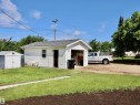 Detached garage with white siding and an asphalt shingle roof - 5530 46 Street, Barrhead, AB 