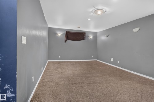 Carpeted room with recessed lighting and wall sconces - 9315 132A Avenue, Edmonton, AB 