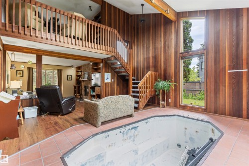 Indoor sunken spa with surrounding terracotta-style tile flooring - 20515 5 Avenue Sw, Edmonton, AB 