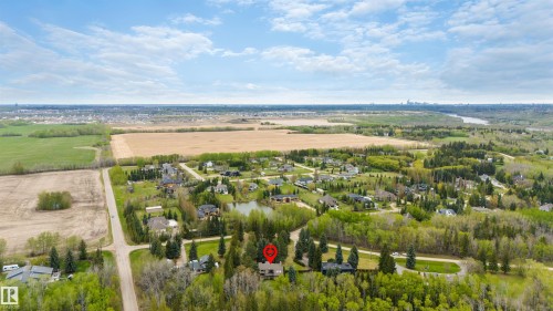 Aerial perspective showcasing a residential area amidst expansive green spaces - 20515 5 Avenue Sw, Edmonton, AB 