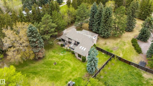Spacious property featuring mature evergreen trees and a private backyard with a fire pit - 20515 5 Avenue Sw, Edmonton, AB 