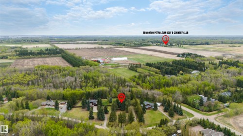 Aerial perspective showcasing a residential property surrounded by mature trees - 20515 5 Avenue Sw, Edmonton, AB 