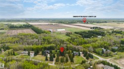 Aerial perspective showcasing a residential property surrounded by mature trees - 