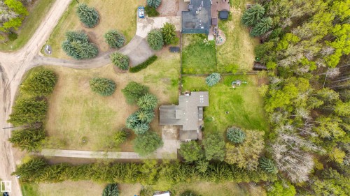 Expansive property featuring a central residence with a gabled roofline, surrounded by mature trees and manicured lawns - 20515 5 Avenue Sw, Edmonton, AB 