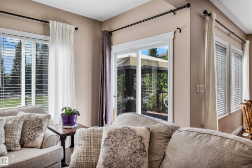 Sliding glass door opening to an outdoor deck area with a gazebo - 18 Voleta Crest, Spruce Grove, AB 