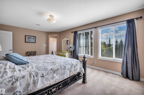 Carpeted room featuring dual windows with blinds, a white trim, and a ceiling-mounted light fixture - 18 Voleta Crest, Spruce Grove, AB 