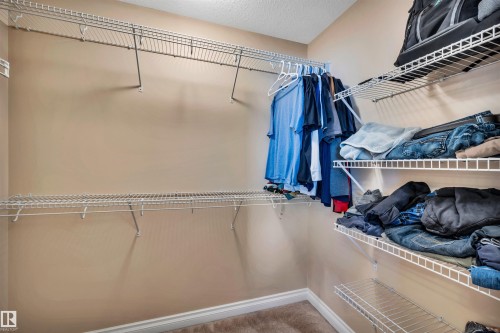 Walk-in closet featuring built-in wire shelving and hanging rods - 18 Voleta Crest, Spruce Grove, AB 