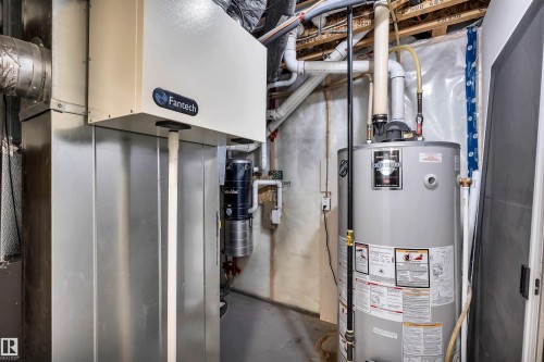 Mechanical room featuring a water heater, furnace, and exposed overhead piping - 18 Voleta Crest, Spruce Grove, AB 