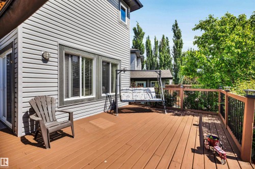 Expansive wood-finish deck with a wood and metal railing system - 18 Voleta Crest, Spruce Grove, AB 