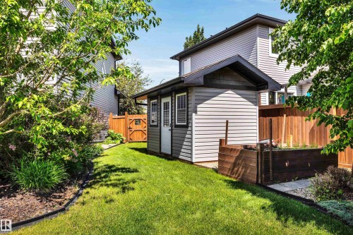 Backyard featuring a dedicated storage shed with horizontal siding and a dark trim roofline - 18 Voleta Crest, Spruce Grove, AB 