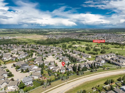 Aerial overview of a residential development featuring numerous single-family homes and Jubilee Park - 18 Voleta Crest, Spruce Grove, AB 