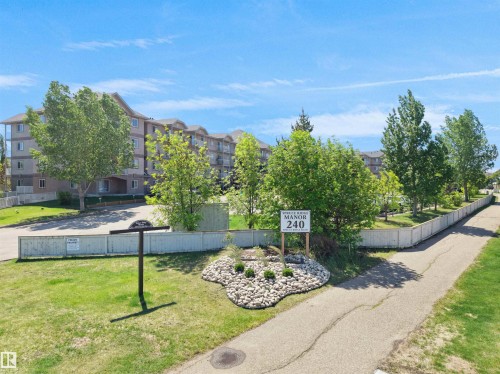 Multi-story building featuring light-colored siding and multiple windows - #217 240 Spruce Ridge Rd, Spruce Grove, AB - Outdoor