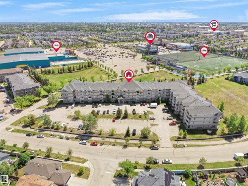 Multi-story residential complex with ample surface parking - #217 240 Spruce Ridge Rd, Spruce Grove, AB - Outdoor With View
