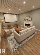 Media room featuring a large projection screen and wood-finish flooring - 