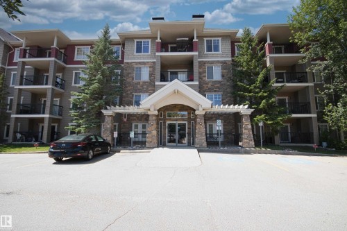 View of apartment building / complex featuring uncovered parking - 311 2098 Blackmud Creek Drive, Edmonton, AB 