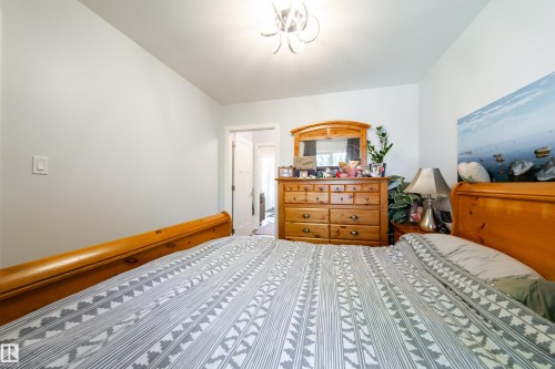White painted walls with a contemporary light fixture - 10811 73 Avenue, Edmonton, AB 