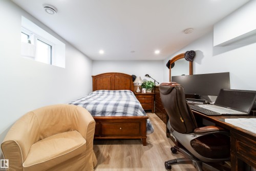 Recessed lighting illuminates wood-finish flooring - 10811 73 Avenue, Edmonton, AB 