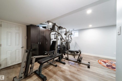 Finished room featuring light wood-finish flooring, white walls, and recessed ceiling lighting - 10811 73 Avenue, Edmonton, AB 