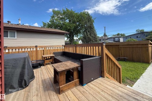 Spacious wood-finish deck with built-in fencing and stairs - 10811 73 Avenue, Edmonton, AB 