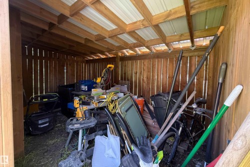 Wood-sided shed with a metal roof and exposed wood framing - 10811 73 Avenue, Edmonton, AB 