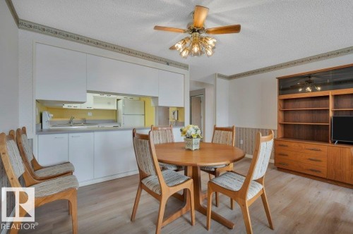 Open-concept living space featuring a wood-finish dining table and coordinated chairs - 316 2011 137 Avenue, Edmonton, AB - Indoor Photo Showing Dining Room