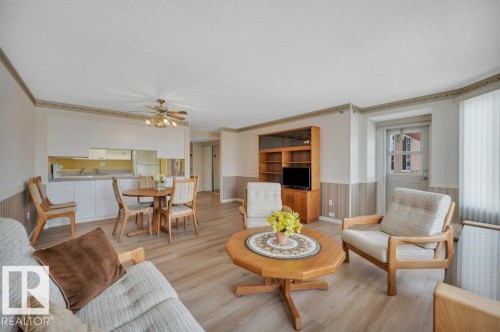 Open-concept living area featuring wood-finish flooring, a built-in entertainment center, and a ceiling fan - 316 2011 137 Avenue, Edmonton, AB - Indoor Photo Showing Living Room