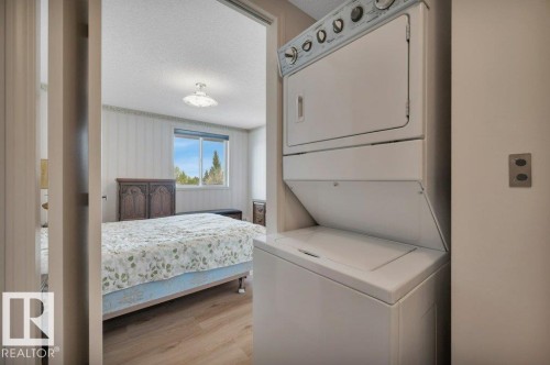 White stacked laundry machines - 316 2011 137 Avenue, Edmonton, AB - Indoor Photo Showing Laundry Room