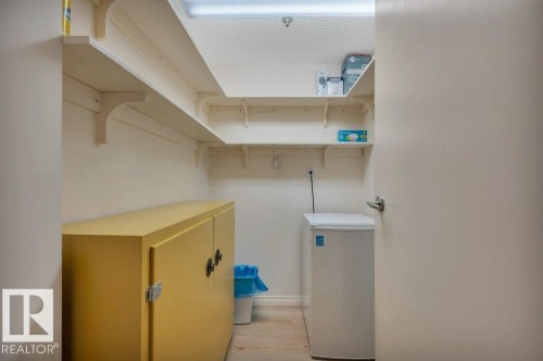 Alcove featuring white walls, wood-finish flooring, and multiple tiers of built-in shelving - 316 2011 137 Avenue, Edmonton, AB - Indoor
