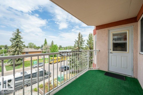 Balcony featuring a white metal railing, green artificial turf flooring, and stucco exterior walls - 316 2011 137 Avenue, Edmonton, AB - Outdoor With Balcony With Exterior