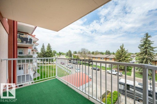 Private balcony with green turf flooring, white metal railing, and an overhead awning - 316 2011 137 Avenue, Edmonton, AB - Outdoor With Balcony With Exterior