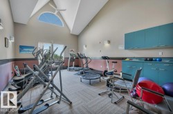 Vaulted ceiling with an arched window and ceiling fan - 