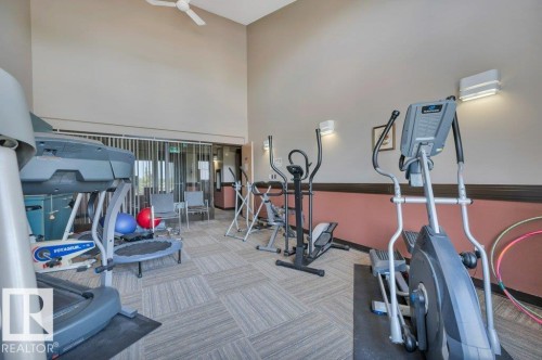Fitness room featuring a patterned carpet, high ceilings, and recessed lighting - 316 2011 137 Avenue, Edmonton, AB - Indoor Photo Showing Gym Room
