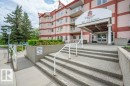 Multi-story building exterior with a covered entrance, prominent signage, and multiple balconies - 316 2011 137 Avenue, Edmonton, AB  - Outdoor 