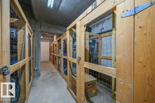 Storage corridor featuring individual wood-framed storage units with wire mesh panels - 316 2011 137 Avenue, Edmonton, AB - Indoor Photo Showing Other Room