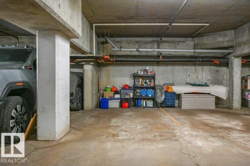 Concrete parking area with exposed concrete walls and ceiling; heated, underground parking stall, assigned - 316 2011 137 Avenue, Edmonton, AB - Indoor Photo Showing Garage
