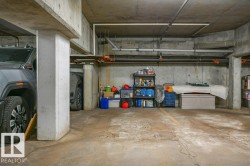 Concrete parking area with exposed concrete walls and ceiling; heated, underground parking stall, assigned - 