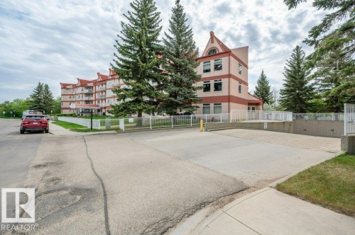 Multi-story building featuring balconies, red roof accents, and a distinctive peak - 316 2011 137 Avenue, Edmonton, AB - Outdoor